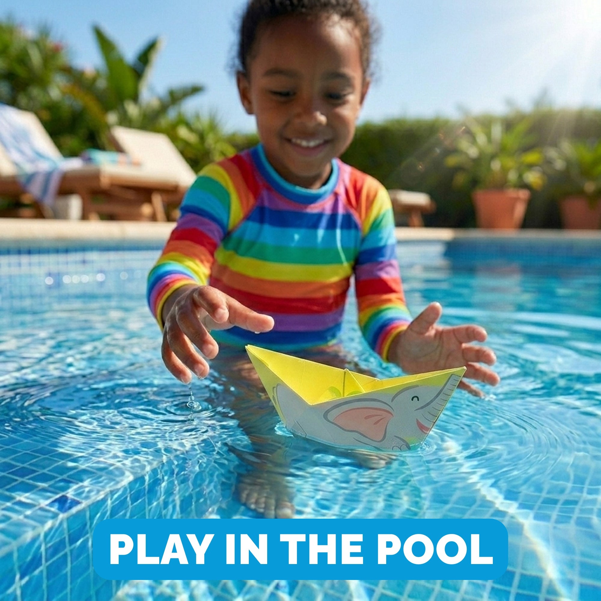 Child floating a WOYS North Set origami paper boat in a swimming pool