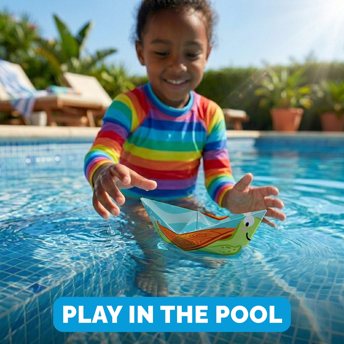 Child playing with a WOYS Marine paper boat in the pool