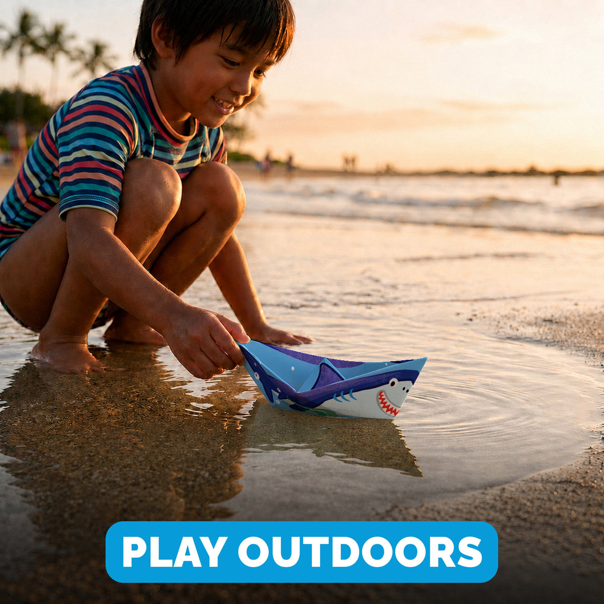 Child playing with a WOYS Marine paper boat outdoors