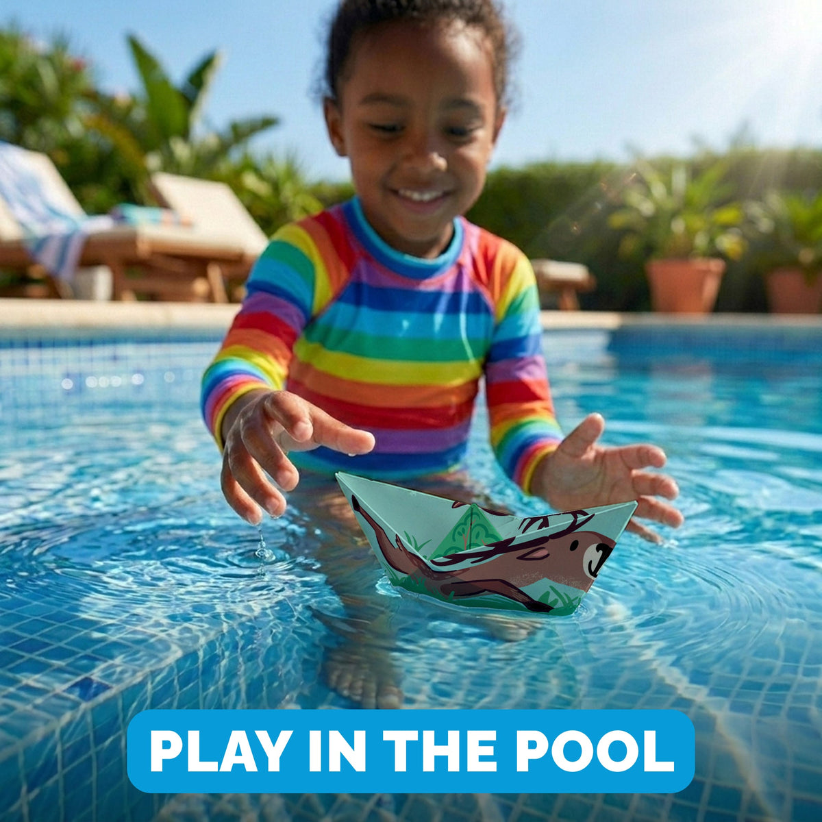 Child playing with a WOYS North paper boat in the pool