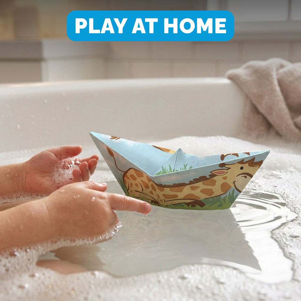 Child floating a WOYS Savannah paper boat in the bath