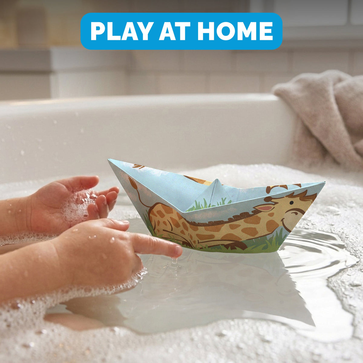 Child floating a WOYS Savannah paper boat in the bath