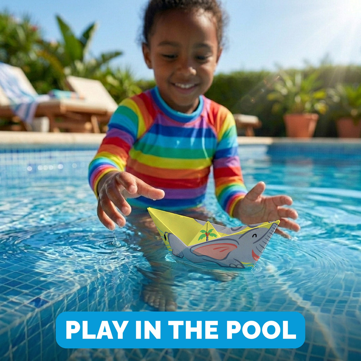 Child playing with a WOYS Savannah paper boat in the pool