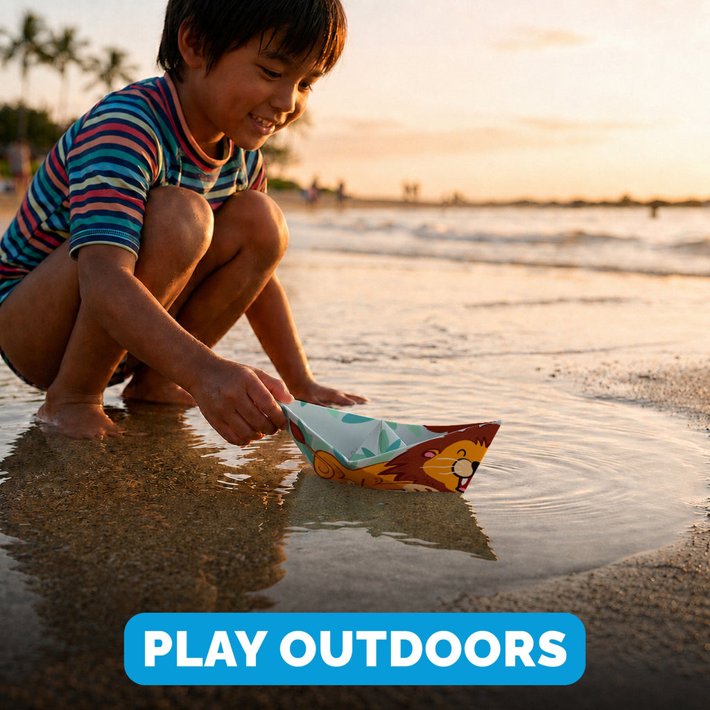 Child playing with a WOYS Savannah paper boat outdoors