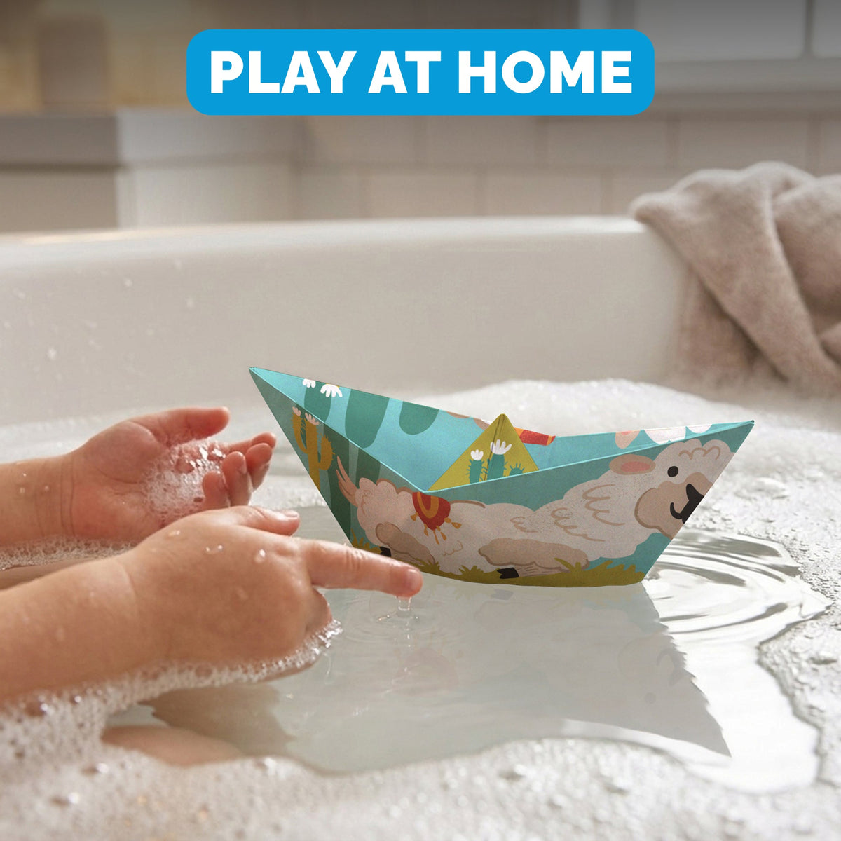 Child floating a WOYS Tropics paper boat in the bath