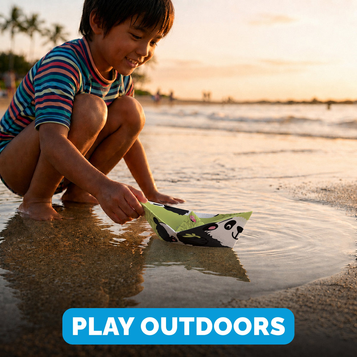 Child playing with a WOYS Tropics paper boat outdoors